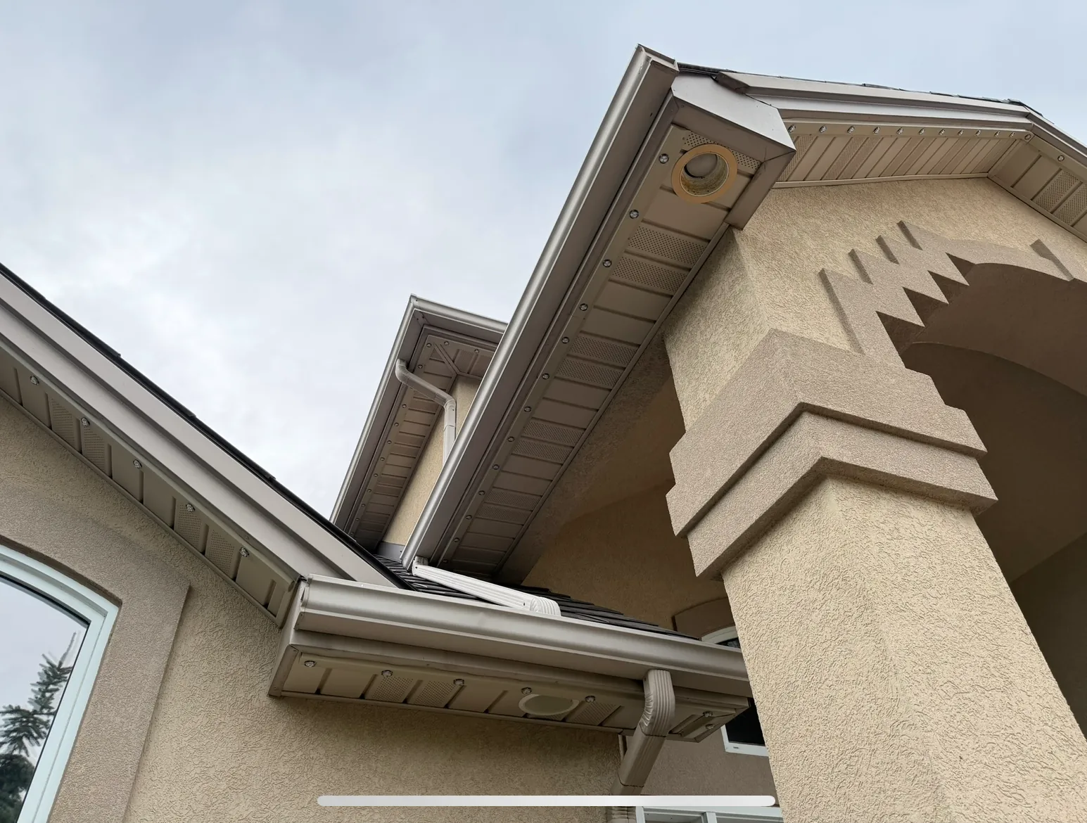 Low-profile lighting channel blending into a home’s trim and soffit during the day